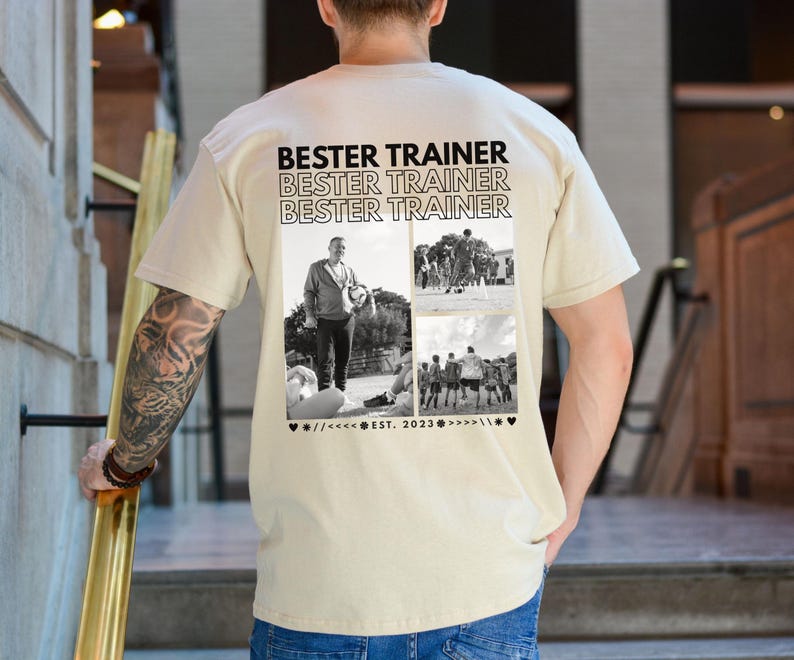 May include: A beige t-shirt featuring the words "BESTER TRAINER" repeated three times. Below the text are three black and white photographs. The bottom of the shirt has the text "EST. 2023" with decorative symbols.