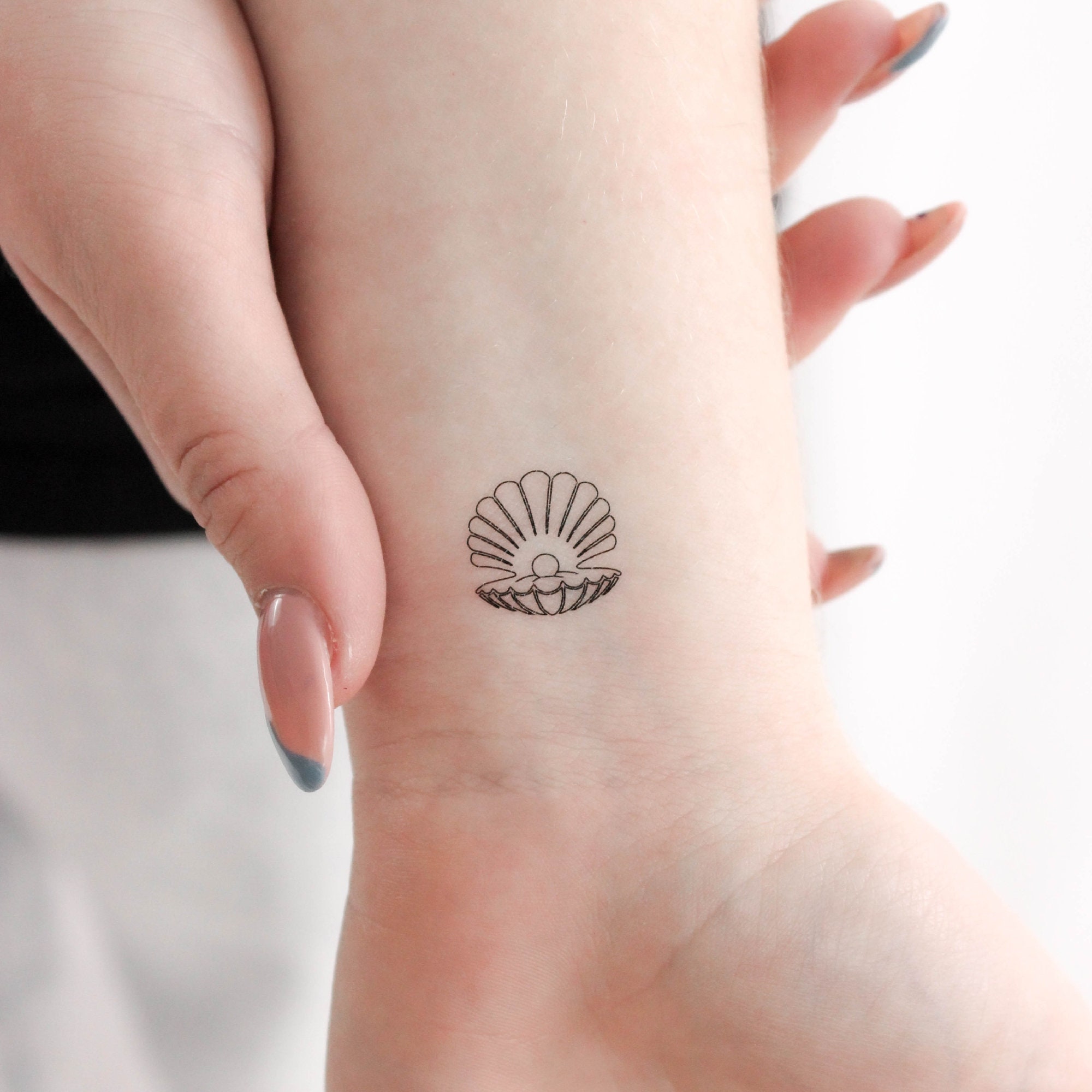 Hand-poked shell tattoo | Shell tattoos, Seashell tattoos, Subtle tattoos