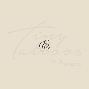 May include: A black cursive letter "E" temporary tattoo, 0.5 inches or 1.2 cm in size, on a light beige background. The text "Tiny Tattoos" and "by tatteco" are also visible.