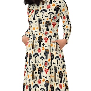 May include: A long-sleeved dress with a cream background and a pattern of black silhouettes of women's faces, red and orange flowers, and other abstract shapes.