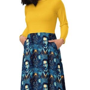 May include: A yellow long-sleeved dress with a blue and white patterned skirt featuring a repeated image of Nikola Tesla. The skirt has pockets on the sides.