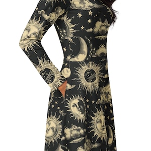May include: A black long-sleeved dress with a vintage celestial print featuring suns, moons, and stars. The dress has a fitted bodice and a flared skirt.
