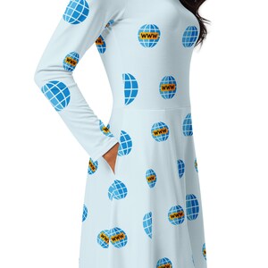 May include: A light blue dress with a long sleeve and a white background. The dress is covered in a repeating pattern of blue globes with the word "WWW" printed in yellow on each globe.