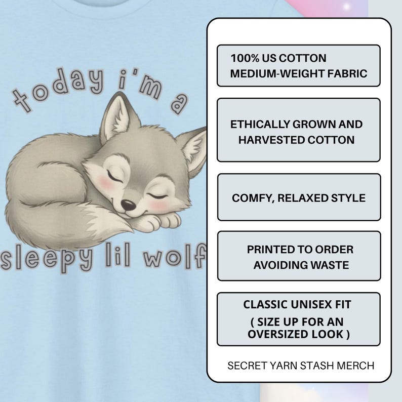 May include: Light blue t-shirt featuring a sleeping cartoon wolf with the text "today i'm a sleepy lil wolf." The shirt also includes text about the fabric and fit. The design is printed on a medium-weight fabric.