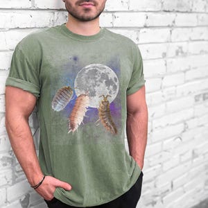 May include: A green t-shirt with a graphic of three pill bugs crawling on the moon. The moon is white and the pill bugs are a variety of colors.