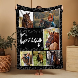 May include: Black fleece blanket featuring a collage of horse images and horseshoe patterns. The word "Daisy" is written in white script across the center. The blanket showcases various horse portraits and scenes.