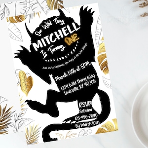 May include: A black and white invitation with gold foil accents. The invitation features a silhouette of the character from the book "Where the Wild Things Are" and the text "Our Wild Thing Mitchell is Turning One. Join us to celebrate the king of all wild things. March 16th at 5PM. 1234 Wild Thing Way Louisville, KY 40206. RSVP Sabrina 123-456-7890 By March 10th."