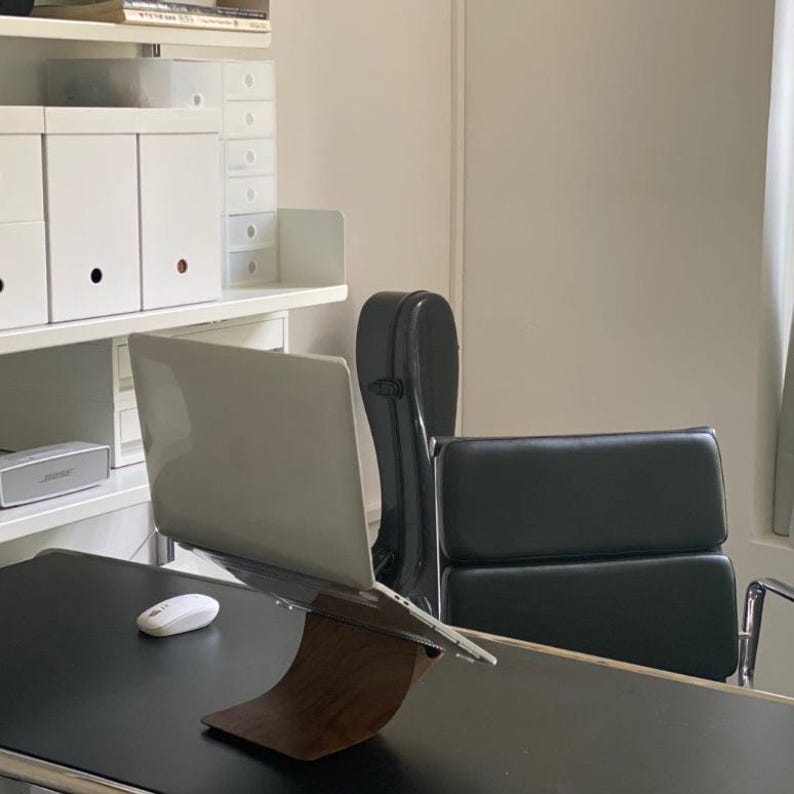 LOOMMA brand walnut wood laptop stand on a desk supporting an Apple MacBook, highlighting durable construction and a sleek design for an enhanced ergonomic workspace