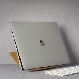 LOOMMA brand walnut wood laptop stand on a desk, supporting an Apple computer with a sleek gray background, showcasing the natural elegance and sturdy design of the stand(2)