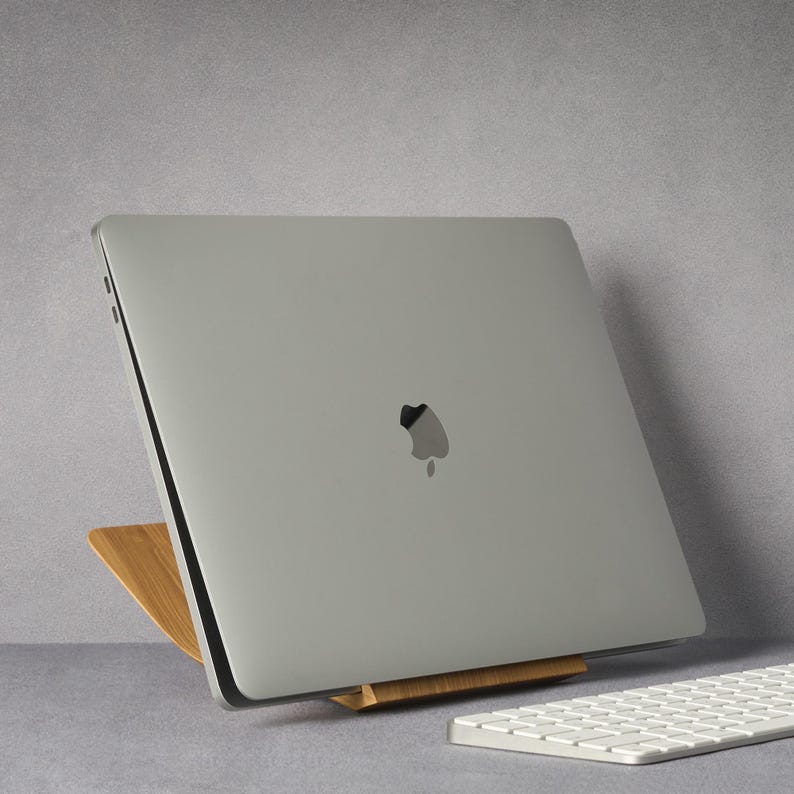 LOOMMA brand walnut wood laptop stand on a desk, supporting an Apple computer with a sleek gray background, showcasing the natural elegance and sturdy design of the stand(2)