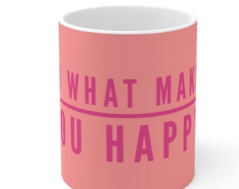 May include: A peach-colored ceramic mug with a pink inscription that reads "Do what makes you happy".
