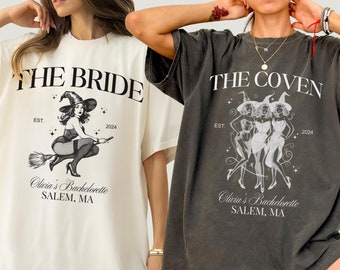 May include: Two oversized t-shirts with a witch theme. The ivory t-shirt has a witch riding a broomstick with the text "THE BRIDE" and "Olivia's Bachelorette SALEM, MA". The grey t-shirt has three witches with the text "THE COVEN" and "Olivia's Bachelorette SALEM, MA".