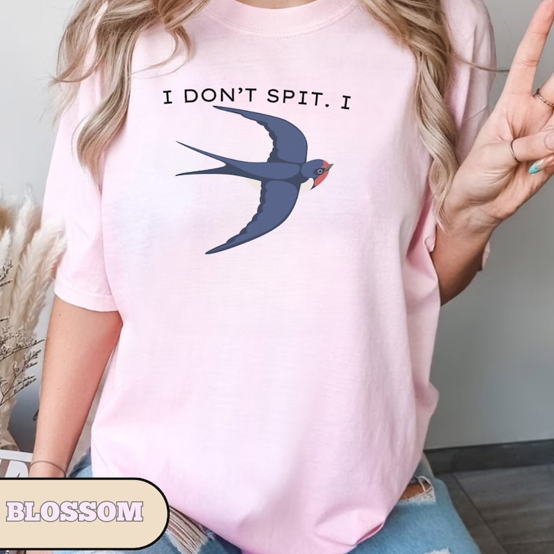 May include: A pink t-shirt with the text "I don't spit. I" and a blue swallow graphic.