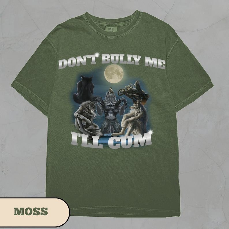 May include: Green t-shirt with a graphic print of wolves and the text "DON'T BULLY ME I'LL CUM".