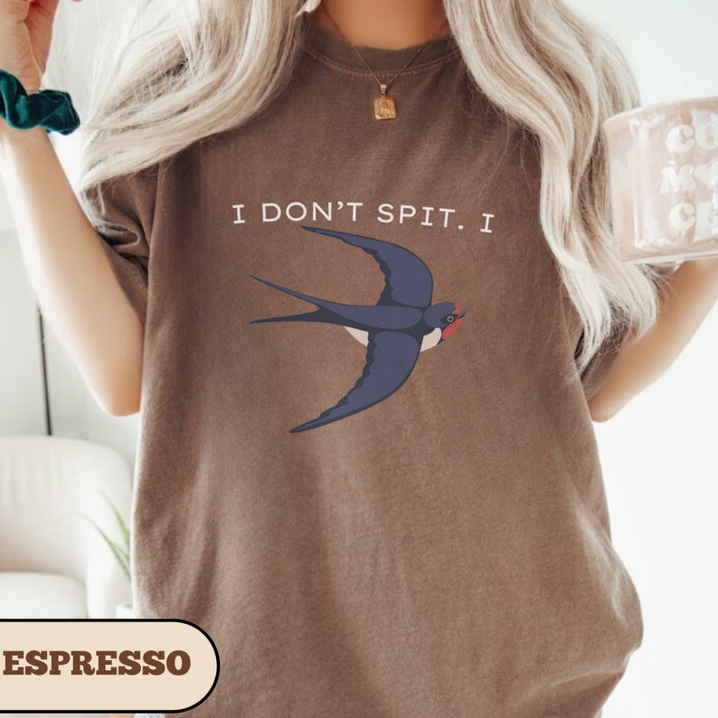 May include: A brown t-shirt with the text "I don't spit. I" and a blue swallow illustration. The word "ESPRESSO" is printed in brown at the bottom of the image.