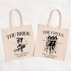 May include: Two beige canvas tote bags with black screen-printed graphics. The left bag features a witch on a broomstick with the text THE BRIDE, EST. 2026, and Olivia's Bachelorette SALEM, MA. The right bag shows three witches with THE COVEN, EST. 2026.