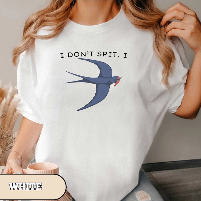 May include: White t-shirt with a blue swallow graphic and the text "I don't spit. I"