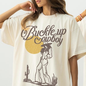 Buckle Up Cowboy Shirt – Hand-Drawn Western Graphic Tee, Boho Aesthetic Gift for Cowgirls & Women, Vintage-Inspired Western T-Shirt for Her
