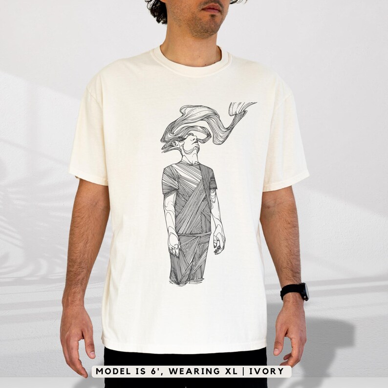 Comfort Colors® ivory graphic T-shirt with Prakash’s hand-drawn line-art figure; shown on a 6' male model wearing size XL to display relaxed fit, full front print, and drape.