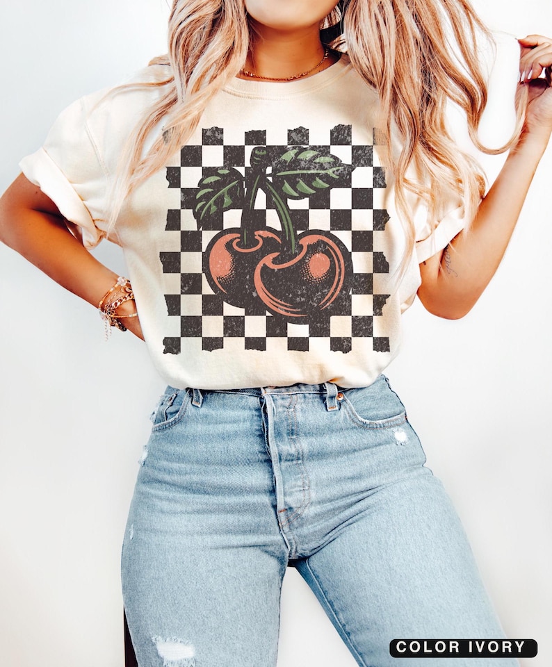 Studio shot of checkered cherries t-shirt – bold cherry pattern on a Comfort Colors vintage tee, perfect for 90s and Y2K fashion lovers. Ivory, vintage white color.