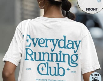 May include: White t-shirt with the text "Everyday Running Club" in teal blue. The design includes the establishment year, stars, and the phrase "We're here for the long run." A smaller image of the front of the shirt is in the upper right corner.