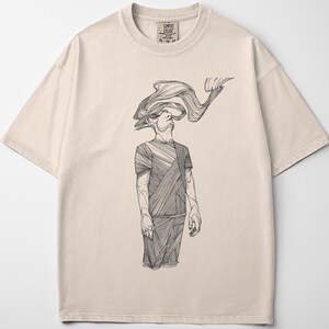 Comfort Colors® ivory unisex T-shirt shown flat on a light background; centered black line-art figure by Prakash printed on the front of a heavyweight cotton tee.