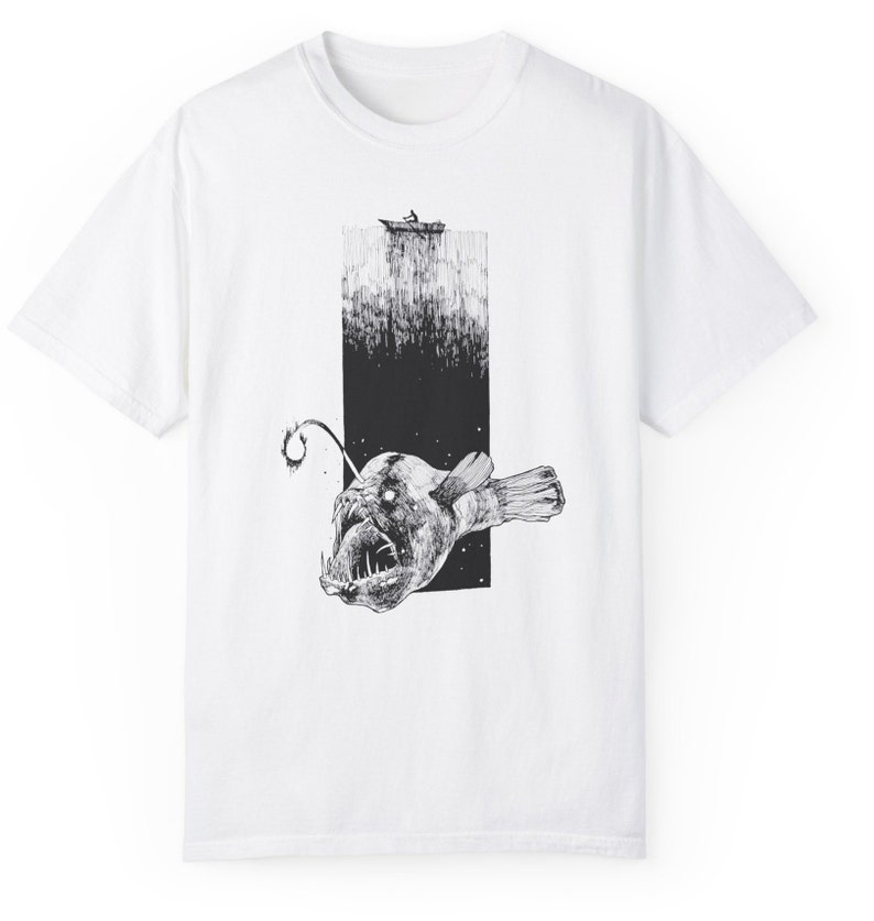product view of comfort colors 1717, white. 
Hand-drawn anglerfish tee featuring a deep ocean scene with a boat and fisherman on the surface. Perfect for nature lovers, fans of retro 90s and 2000s style, and grunge fashion enthusiasts.
