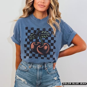 Comfort colors blue jean checkered tshirt for women with a retro bold cherry print. Distressed style for a worn in look.