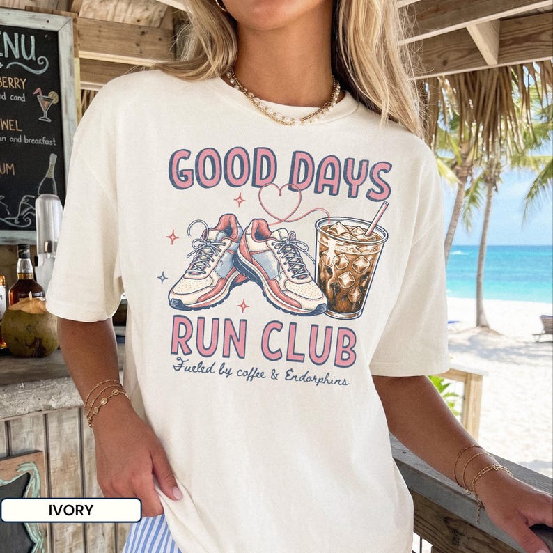 Comfort Colors® run club shirt with Good Days graphic, sneakers, iced coffee, and retro pink and navy lettering. Cute running shirt for women, coffee lover gift, casual runner outfit, oversized workout tee, shown on Blossom, Ivory, and White tees.