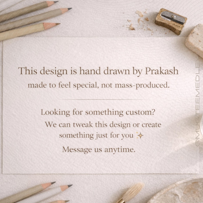 May include: A textured, off-white paper with text that reads, "This design is hand drawn by Prakash made to feel special, not mass-produced." Additional text offers custom design services. Pencils, a sharpener, and an eraser are scattered around.