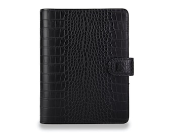 May include: Black leather planner with a crocodile embossed pattern and a black flap closure with a silver metal clasp.