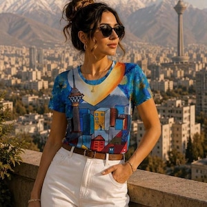 May include: A short-sleeved t-shirt featuring a vibrant, multi-colored graphic print of a cityscape with a tall tower and a large sun, paired with high-waisted white denim pants and a brown leather belt with a silver buckle.