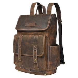 May include: A brown leather backpack with a large front pocket and a smaller pocket on the side. The backpack has a distressed look and the brand name "SAINT SRB" is embossed on the front flap.