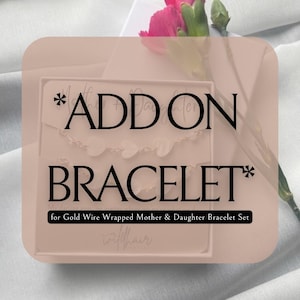 Puede incluir: Una caja rosa con el texto "*ADD ON BRACELET* for Gold Wire Wrapped Mother & Daughter Bracelet Set" y la palabra "witchair" en cursiva.