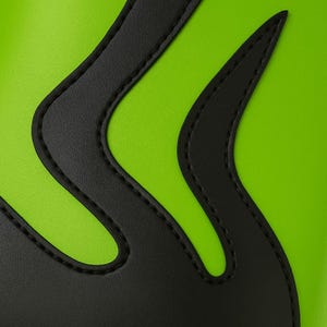 Close-up angled view of handmade neon green wrestling boots with black flame pattern, crafted from authentic leather. Boots feature black outsole, lace-up front, and smooth stitched finish. Captured on bright white background to highlight glossy surface, flame curves, and premium detail. Designed for wrestling professionals, unisex fighters, and cosplay enthusiasts seeking standout custom footwear.