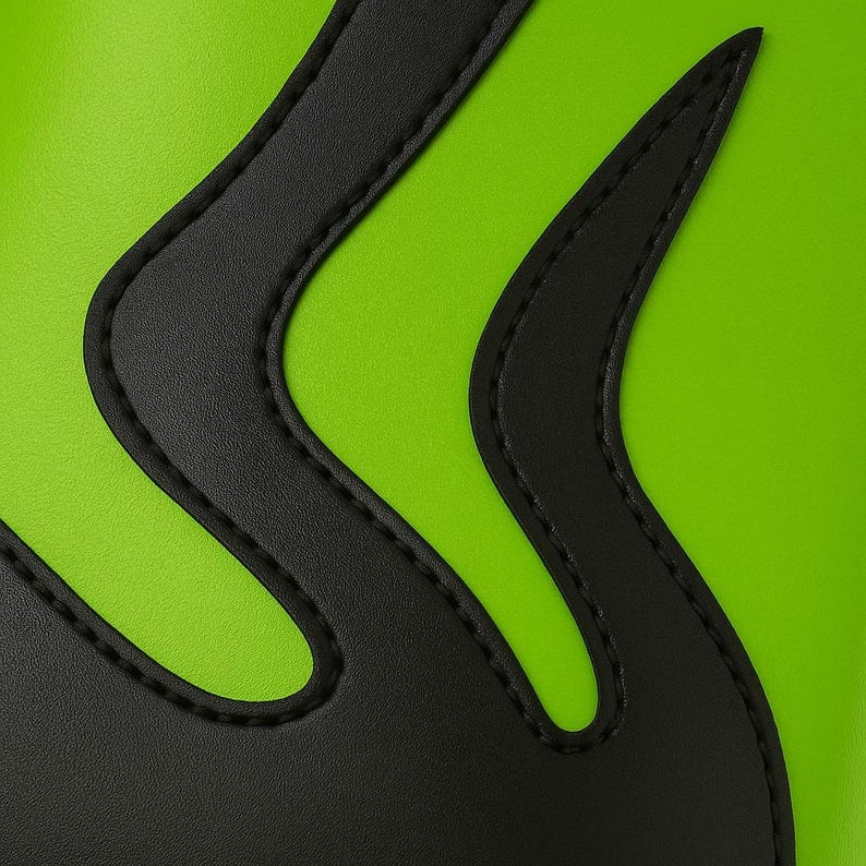 Close-up angled view of handmade neon green wrestling boots with black flame pattern, crafted from authentic leather. Boots feature black outsole, lace-up front, and smooth stitched finish. Captured on bright white background to highlight glossy surface, flame curves, and premium detail. Designed for wrestling professionals, unisex fighters, and cosplay enthusiasts seeking standout custom footwear.