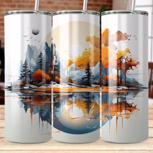 May include: Three stainless steel tumblers featuring a watercolour-style design of a mountain scene with a reflection in water. The scene depicts a mountain range, trees, and a sky with a sun.