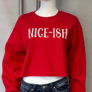 May include: Red cropped sweatshirt with white text that reads "NICE-ISH".