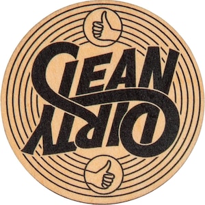 May include: A round, brown coaster with a black and white design. The design features the words "Clean Dirty" in a stylized font, with a thumbs up symbol above and below the text.
