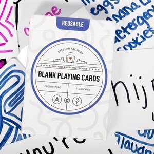 May include: A pack of 52 blank playing cards with a blue and white circular design. The text on the pack reads "Stellar Factory Dry Erase & Wet Erase Friendly Blank Playing Cards Prototyping Flashcards".