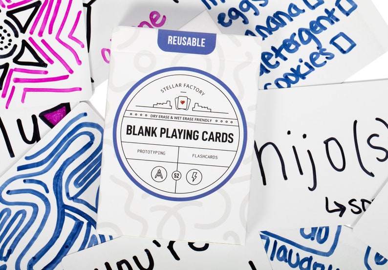 May include: A pack of 52 blank playing cards with a blue and white circular design. The text on the pack reads "Stellar Factory Dry Erase & Wet Erase Friendly Blank Playing Cards Prototyping Flashcards".
