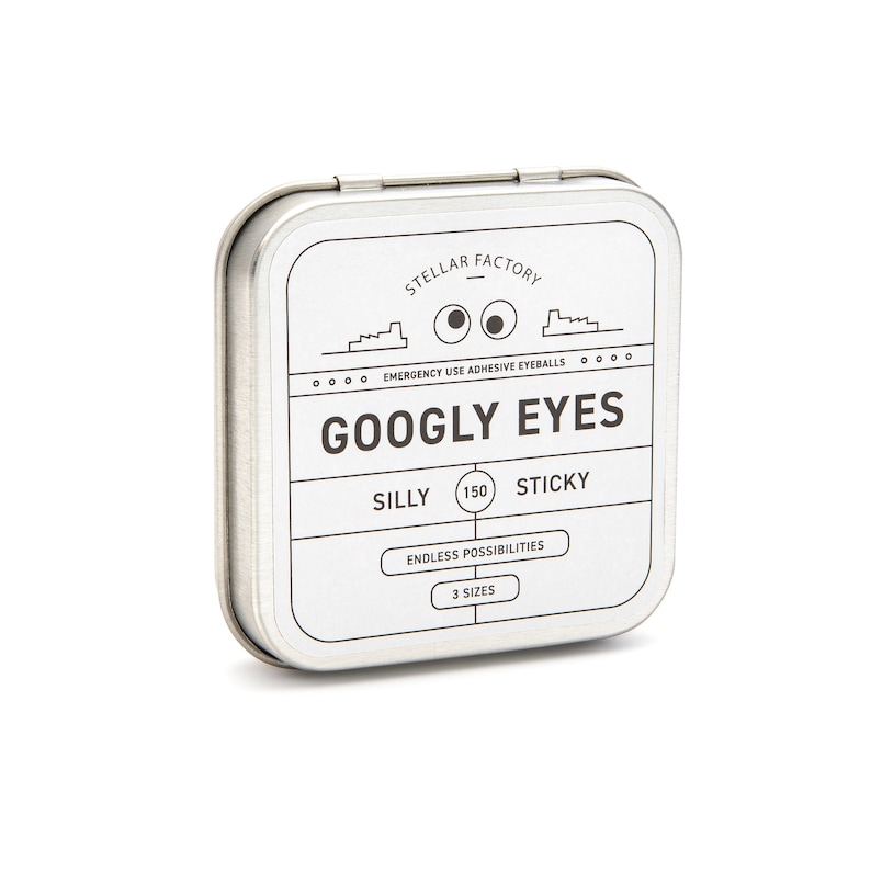 May include: A silver tin with a white label that says "STELLAR FACTORY" and "GOOGLY EYES". The label also says "EMERGENCY USE ADHESIVE EYEBALLS", "SILLY", "150", "STICKY", "ENDLESS POSSIBILITIES", and "3 SIZES".