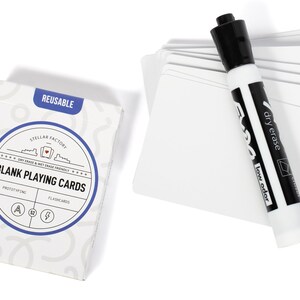 May include: A pack of blank white playing cards with a dry erase marker. The card box is white with blue and black text that reads "Stellar Factory" and "Blank Playing Cards". The text "Reusable" is printed in blue on the top of the box.