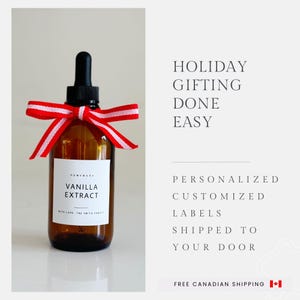 May include: A brown glass bottle with a dropper top, tied with a red and white ribbon. The bottle has a white label that reads "Homemade Vanilla Extract" with the text "With Love, The Smith Family".