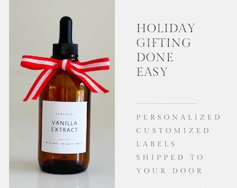May include: A brown glass bottle with a dropper top, tied with a red and white ribbon. The bottle has a white label that reads "Homemade Vanilla Extract" with the text "With Love, The Smith Family".