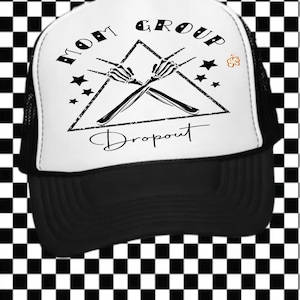 May include: Black and white trucker hat with the text "MOM GROUP Dropout". The hat features a white front panel with a black graphic of crossed skeleton hands inside a triangle, surrounded by stars. The brim and mesh back are black.