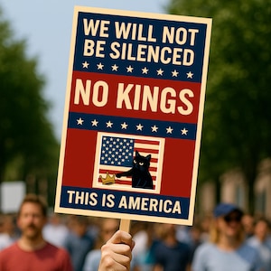May include: A protest sign held up in a crowd. The sign has the words "WE WILL NOT BE SILENCED" and "NO KINGS" in bold text. Below is a graphic of the American flag with a black cat and a crown. The words "THIS IS AMERICA" are at the bottom.