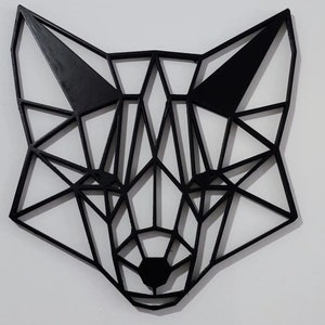 May include: Black geometric fox head wall decor made of wood. The fox head is made up of many triangles and is a modern and minimalist design.