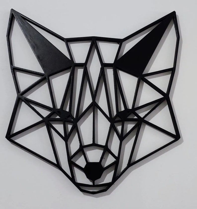 May include: Black geometric fox head wall decor made of wood. The fox head is made up of many triangles and is a modern and minimalist design.