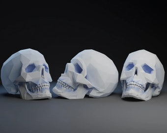 May include: Three white, geometric skull sculptures with blue accents. The skulls are arranged in a row, with the middle skull facing forward and the other two skulls facing slightly to the side.